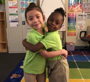 Two students hugging
