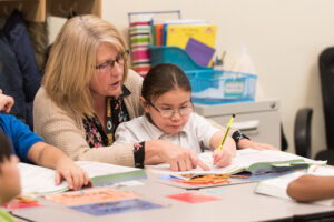 Teachers helping a child study