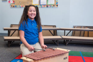 Student playing xylophone in music class