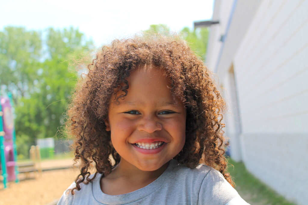 close-up pic of a Kindergarten girl with a big smile on her face